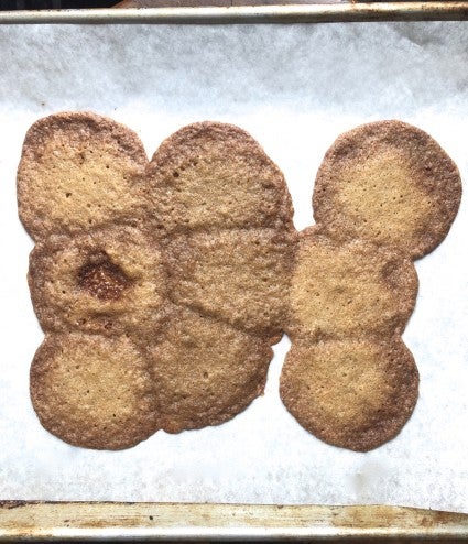 Baked cookies spread into a giant puddle on a baking sheet.